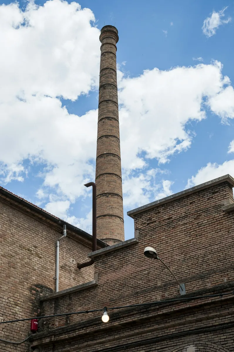 Edifici de maó amb una xemeneia industrial a Manresa